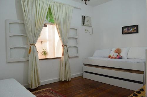 a bedroom with two beds and a window at Grand Maison Du Fort in Škorak