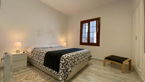a bedroom with a bed and a table and a window at Casa Pepa y Argeo in Mazo