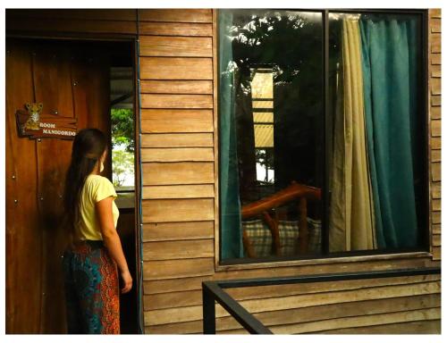 a woman is standing outside of a window at Terrazas del Golfo in La Palma