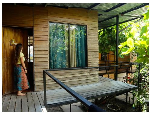 a woman standing on the porch of a house at Terrazas del Golfo in La Palma
