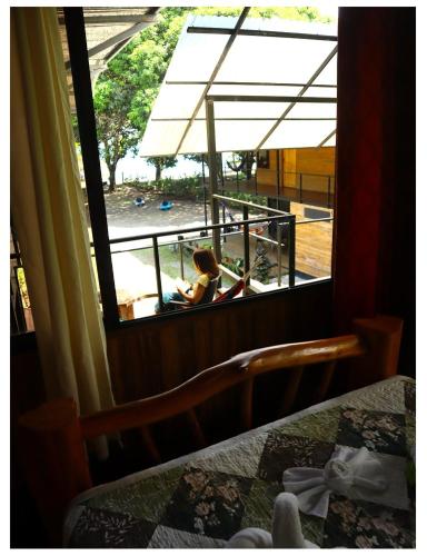 a woman looking out of a window at a view of a building at Terrazas del Golfo in La Palma