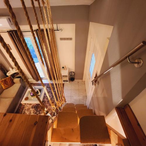 a group of chairs in a room with stairs at Luxury Loft Apartment Sofia in Patra