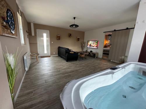 eine große Badewanne im Wohnzimmer in der Unterkunft Victory Lodge spa in Choisy-la-Victoire