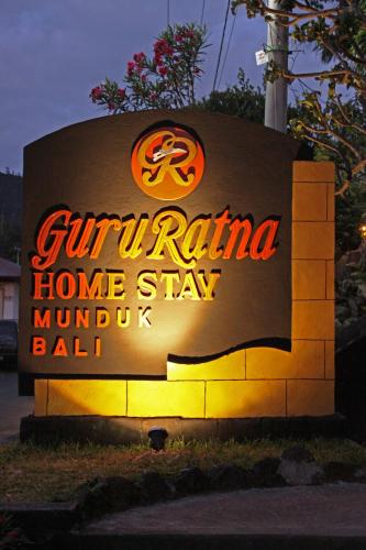 a sign for a guririno home stayimum ball at Guru Ratna in Munduk