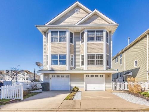 a large house with a white fence in front of it at Balcony View, Updated Interior, Close to the Beach! in Atlantic City