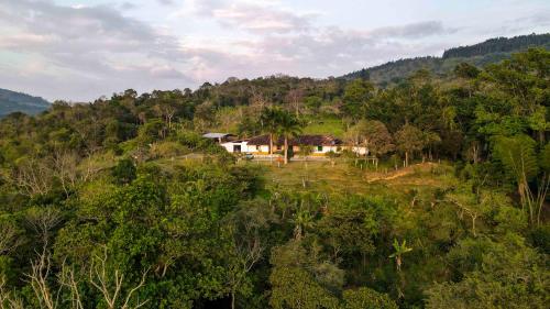 a house on top of a hill with trees at La Hacienda in San Gil