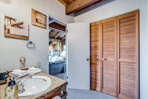 a bathroom with a sink and a bedroom at The Glass House in Sea Ranch
