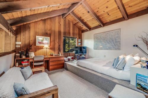a bedroom with a large bed and a desk at The Glass House in Sea Ranch
