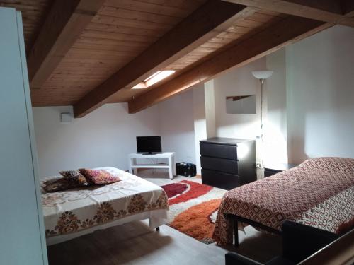 a bedroom with a bed and a desk with a tv at Casalborsetti Porto Reno in Casal Borsetti