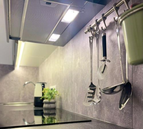 a kitchen with utensils hanging on the wall at Ferienwohnung Bloom in Bernkastel-Kues