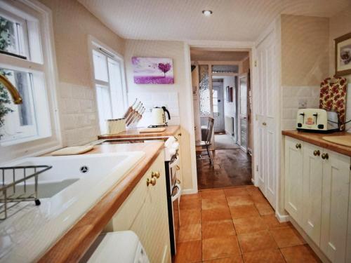 a kitchen with a sink and a counter top at Cherry Blossom Cottage ,4 Cherry Street , Old Town ,Stratford Upon Avon in Shottery