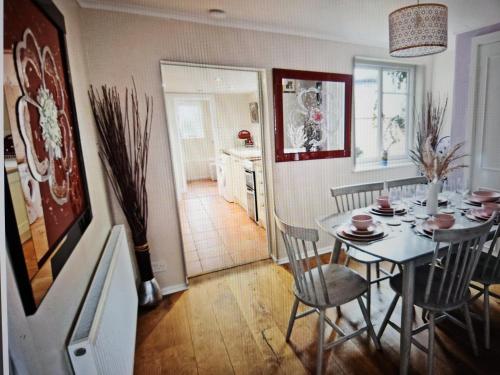 a kitchen and dining room with a table and chairs at Cherry Blossom Cottage ,4 Cherry Street , Old Town ,Stratford Upon Avon in Shottery