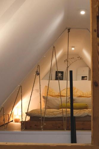 a bed in the attic of a room at Helles modernes City-Loft in Freudenstadt