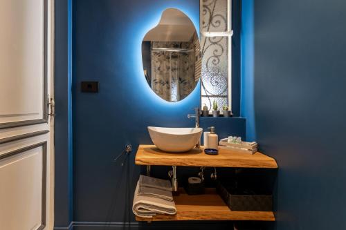 a bathroom with a bowl sink and a blue wall at Il Sogno nel Cassetto in Turin