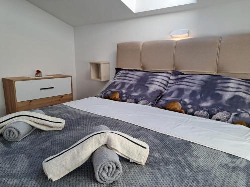 a bedroom with a bed with towels on it at Apartments Sofie & Emily in Gornji Karin