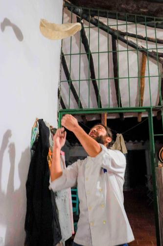 a chef is standing next to a bunk bed at La Hacienda in San Gil