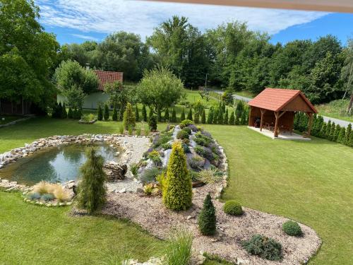 a garden with a pond and a gazebo at Apartmány Přeseka in Třeboň