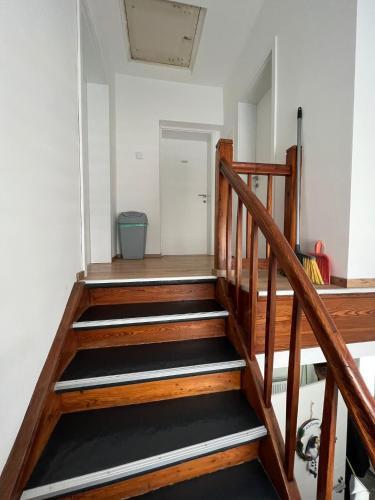 a wooden staircase in a room with a door at S&D in Kapfenberg