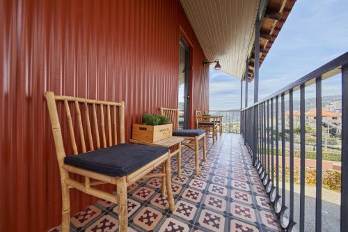 a row of chairs on the balcony of a building at THE PINTA Boutique in Armamar