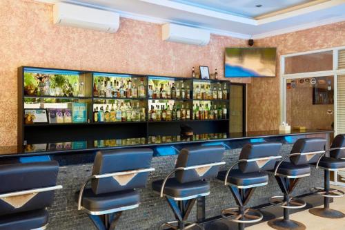 a bar in a restaurant with blue chairs and liquor bottles at View Talay Villas - Luxury, 2 Bedroom - private pool villa, 500m from Jomtien beach - VTV 45 in Jomtien Beach