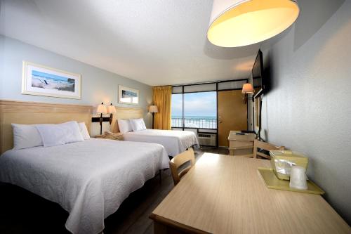 a hotel room with two beds and a view of the ocean at Holiday Sands North "On the Boardwalk" in Myrtle Beach