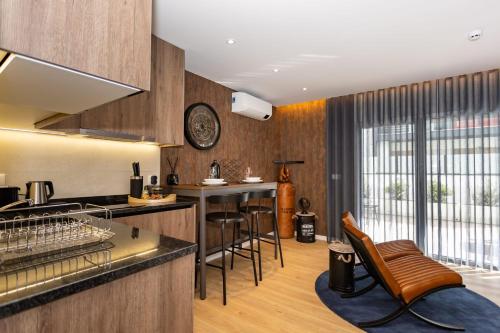 a kitchen with a counter and chairs in a room at Marinha Grande Apartamentos N4 FACTORY in Marinha Grande