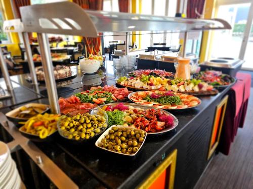 a buffet line with many different plates of food at Alexa Hotel in Göhren