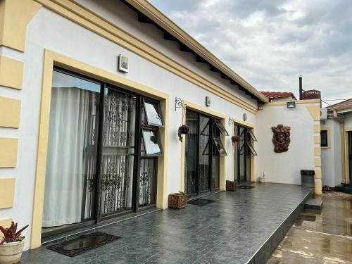 a building with large glass doors on a courtyard at Aerodrome Lodge and Conference Centre in Benoni