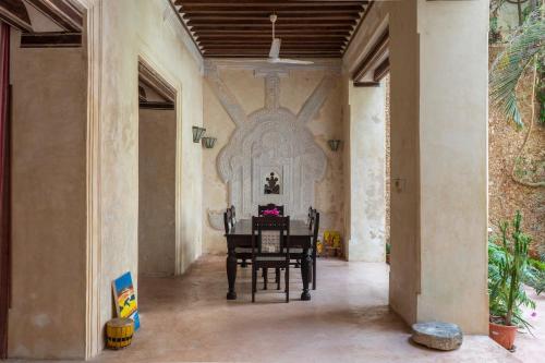 a dining room with a table in a building at Amma's House in Lamu