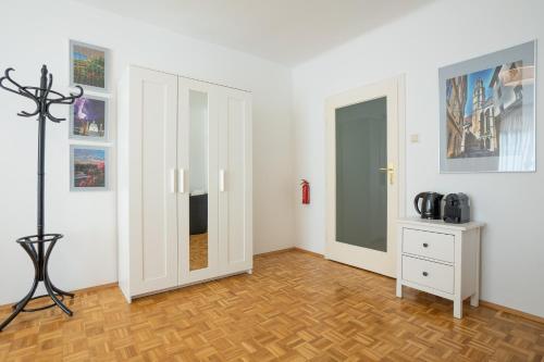 a room with two doors and a wooden floor at Central living - Stephansdom Apartments in Vienna
