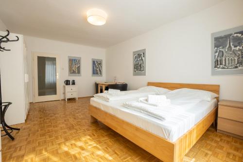 sypialnia z dużym łóżkiem i drewnianą podłogą w obiekcie Central living - Stephansdom Apartments w Wiedniu
