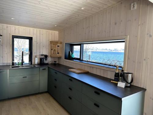 a kitchen with a large window and a counter top at Cabin in Tromsø in Tromsø