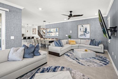 a living room with two couches and a dining room at Villatel at Harbor Island Beach Club in Melbourne Beach