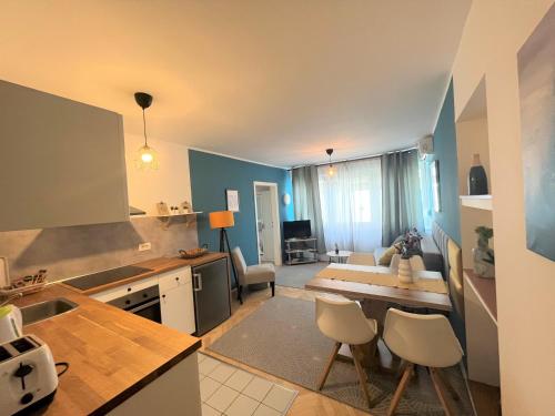 a kitchen and living room with a table and chairs at Cosy apartment - Zagreb Downtown with own parking spot in the garage in Zagreb