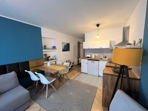 a kitchen and living room with a couch and a table at Cosy apartment - Zagreb Downtown with own parking spot in the garage in Zagreb