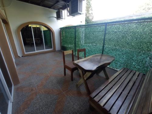 a bench and a table and a chair on a balcony at Palmas de Chahue in Santa Cruz Huatulco