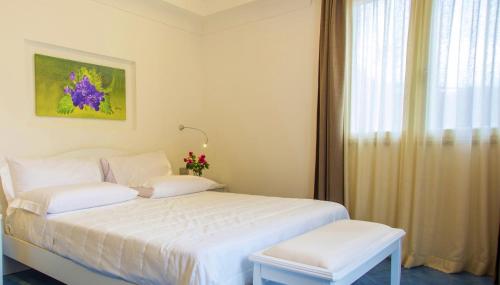 a bedroom with a white bed and a window at Tenuta Solomita in Maiori