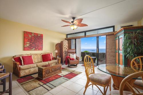 a living room with a couch and a table at Kona Reef Comfort D6 in Kailua-Kona