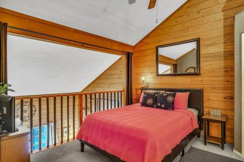 a bedroom with a bed on a balcony with a mirror at 3 Bedroom Log Cabin Condo close to Everything! in Branson