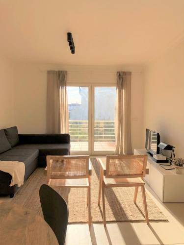 a living room with two chairs and a couch at Sea Avenue House - center Baleal - walk to surf in Ferrel