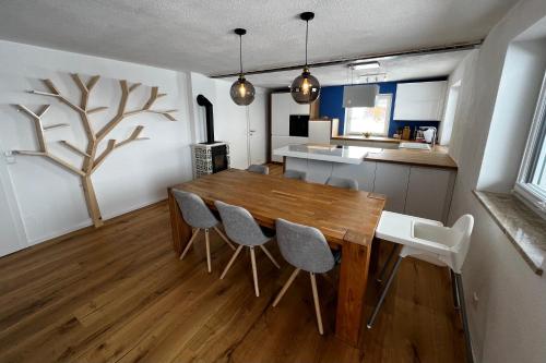 a kitchen and dining room with a wooden table and chairs at Haus Bergfeld with the view over Dachstein in Ramsau am Dachstein
