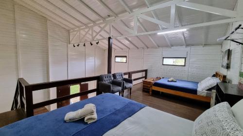 sypialnia z 2 łóżkami i biurkiem w obiekcie Casa do Beija-Flor w mieście Florianópolis