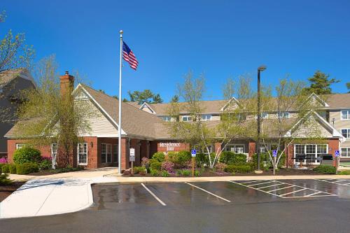 a building with an american flag in front of it at Residence Inn Portland Scarborough in Scarborough