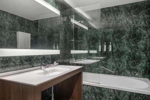 a bathroom with a white sink and a shower at AC Hotel Zamora by Marriott in Zamora