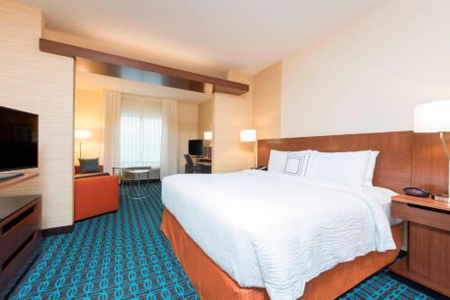 um quarto de hotel com uma cama grande e uma televisão de ecrã plano em Fairfield Inn & Suites by Marriott Fredericksburg Texas em Fredericksburg