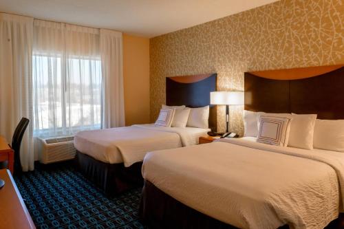 a hotel room with two beds and a window at Fairfield Inn & Suites Kennett Square in Kennett Square