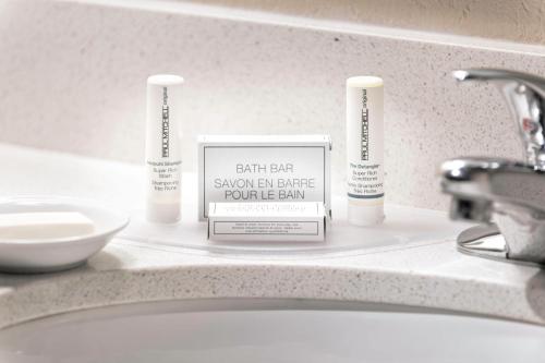 a bathroom counter with three bathroom products on it at SpringHill Suites by Marriott Bentonville in Bentonville