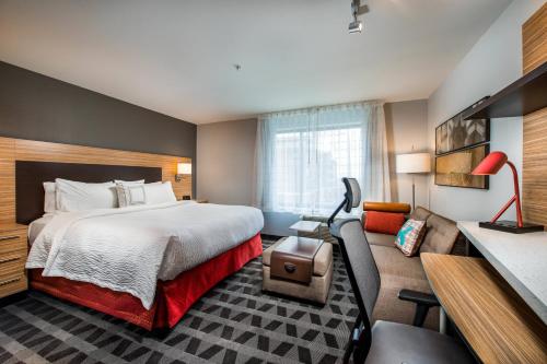 a hotel room with a bed and a couch at TownePlace Suites by Marriott Waco South in Waco