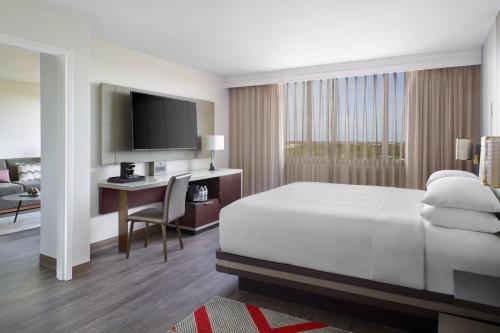 a hotel room with a bed and a desk at Marriott Kansas City Overland Park in Overland Park