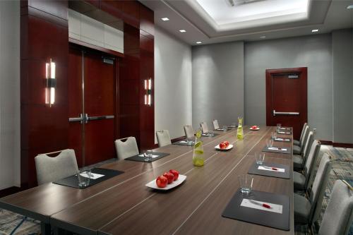a conference room with a long wooden table and chairs at Marriott Kansas City Overland Park in Overland Park
